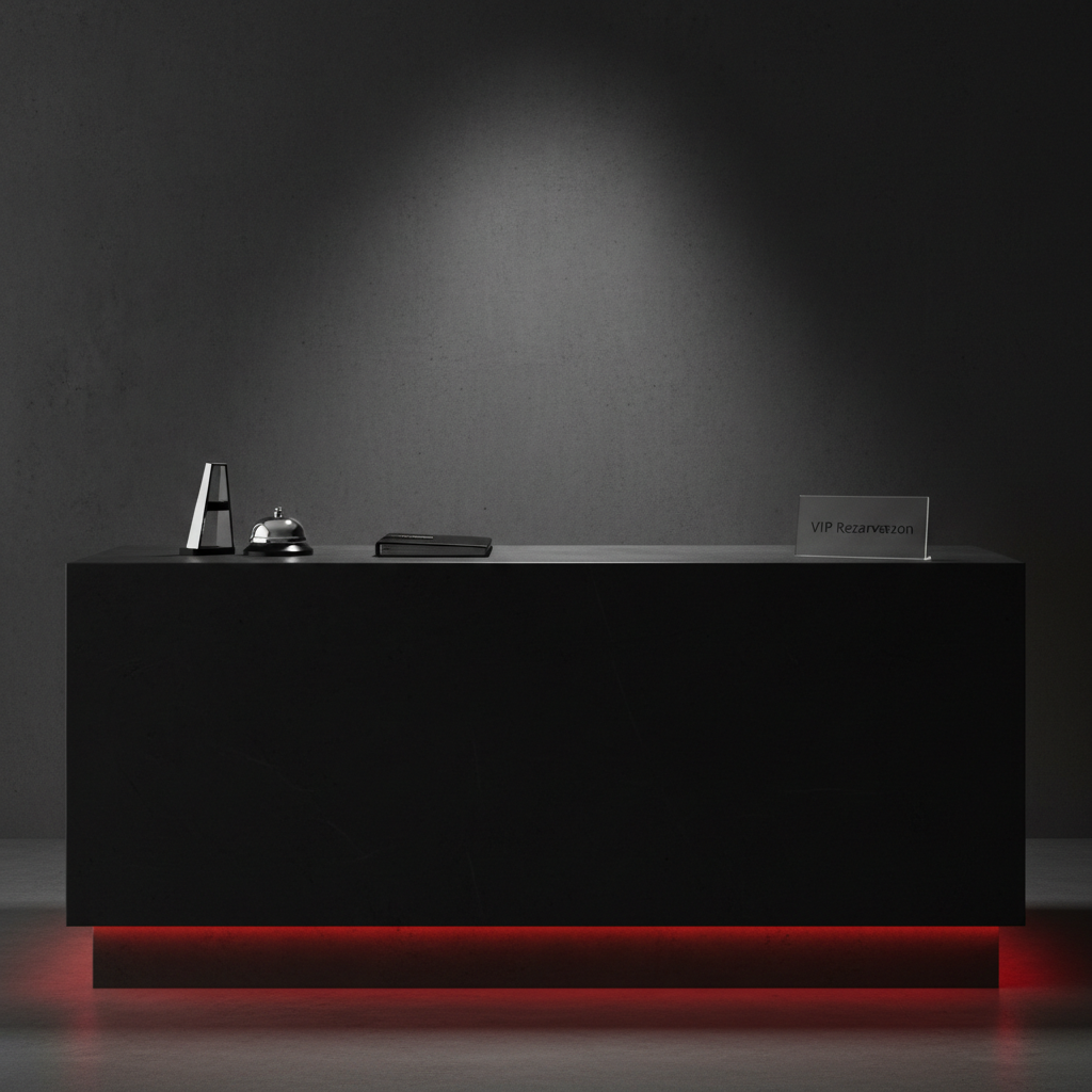 An ultra-modern, dim reception desk in a boutique-style office, built from matte black stone with a thin, luminous red LED line tracing its bottom edge. On the desk sits a single, stylish silver desk bell, a closed black appointment book, and a minimalist, frosted glass sign that reads “VIP Rezervasyon” in sharp, clean typography. A focused overhead spotlight creates sharp, controlled shadows, emphasizing the contours of the bell and the crisp edges of the desk. The background wall is a smooth, dark concrete surface with a subtle, diagonal light streak, adding depth without distraction. Captured straight-on at eye level with tight framing and photographic realism, the mood is professional, confidential, and boldly high-end, perfectly suited to a discreet, premium service environment.